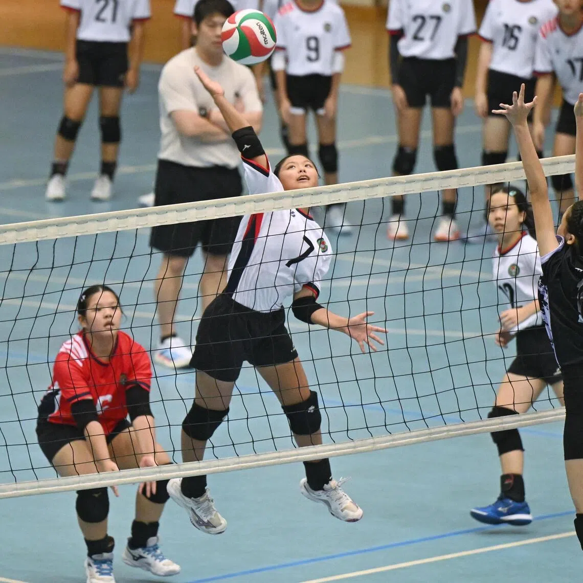 Bukit Panjang Government High School’s captain Brenda Tan (white) spiking the ball against Nanyang Girls’ High School (black) at the National School Games C Div Girls’ volleyball final at Our Tampines Hub on Aug 31.