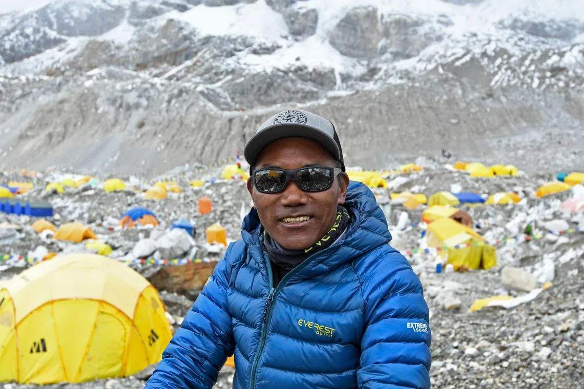 (FILES) In this file photo taken on May 2, 2021, Nepal's mountaineer Kami Rita Sherpa poses for a picture during an interview with AFP at the Everest base camp in the Mount Everest region of Solukhumbu district. Kami Rita Sherpa reached the top of Mount Everest for the 27th time on May 17, reclaiming the record for the most summits of the world's highest mountain. (Photo by Prakash MATHEMA / AFP)
