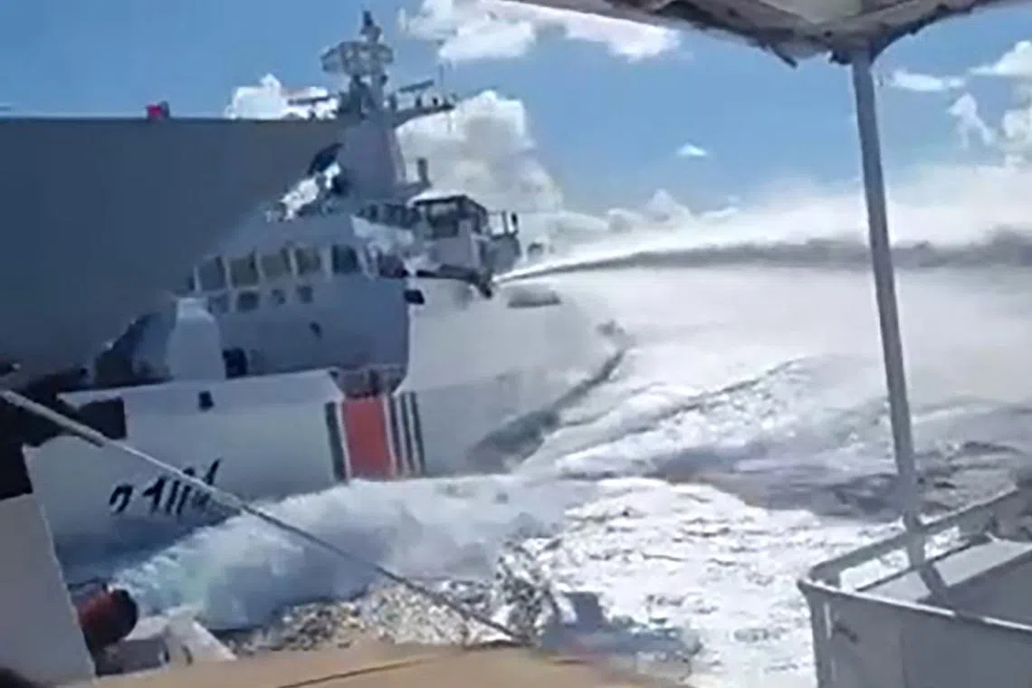 An incident between a Chinese Navy vessel (far left, bow pictured) and a Chinese Coast Guard ship (second from left) as seen from a Philippine boat in the South China Sea on Aug 11.