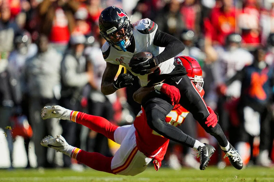 FILE PHOTO: Dec 21, 2024; Kansas City, Missouri, USA; Houston Texans wide receiver Tank Dell (3) is tackled by Kansas City Chiefs safety Justin Reid (20) during the first half at GEHA Field at Arrowhead Stadium. Mandatory Credit: Jay Biggerstaff-Imagn Images/File photo