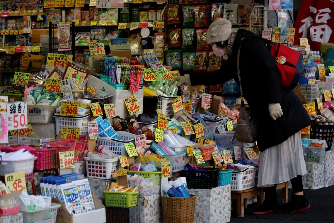 A woman chooses products at a drug store in Tokyo, Japan on Jan 10, 2023. 
