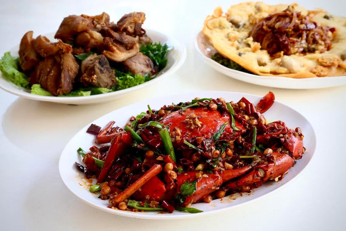 From top left, clockwise: Signature Pork Knuckle, Giant Oyster Omelette and Mala Crab at Xiao Hei Tze Char’s new outlet in New Upper Changi Road. 