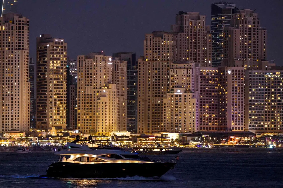This picture shows the Dubai skyline as a yacht sails past on June 11, 2025. (Photo by FADEL SENNA / AFP)
