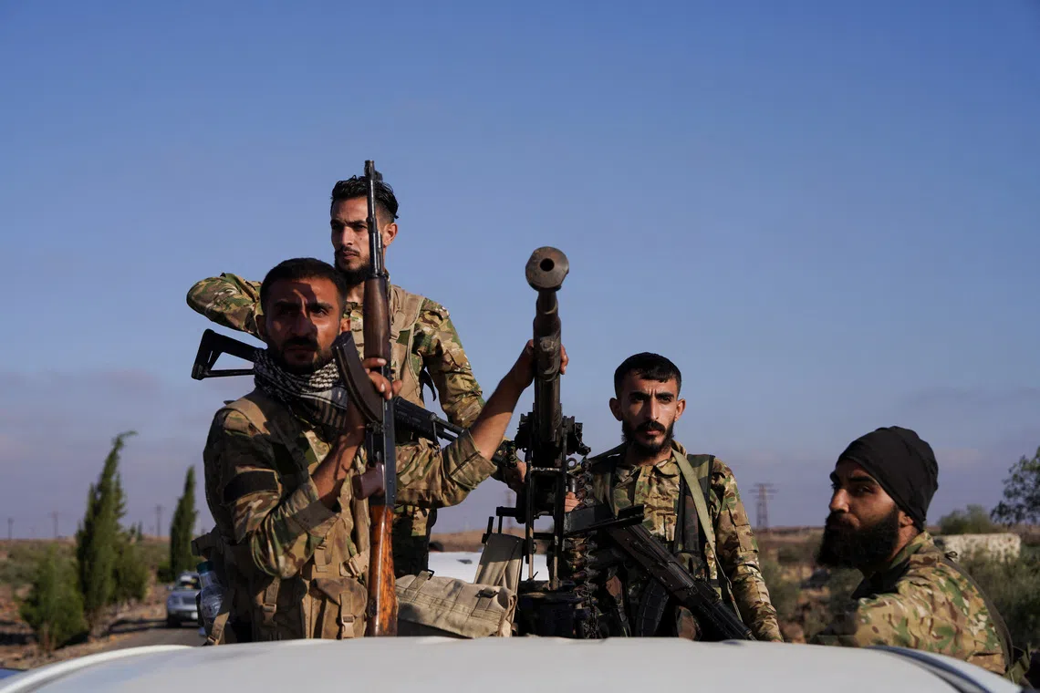 Members of Syrian security forces ride on a back of a truck in Druze city in Sweida, Syria July 15, 2025. REUTERS/Karam al-Masri/File Photo