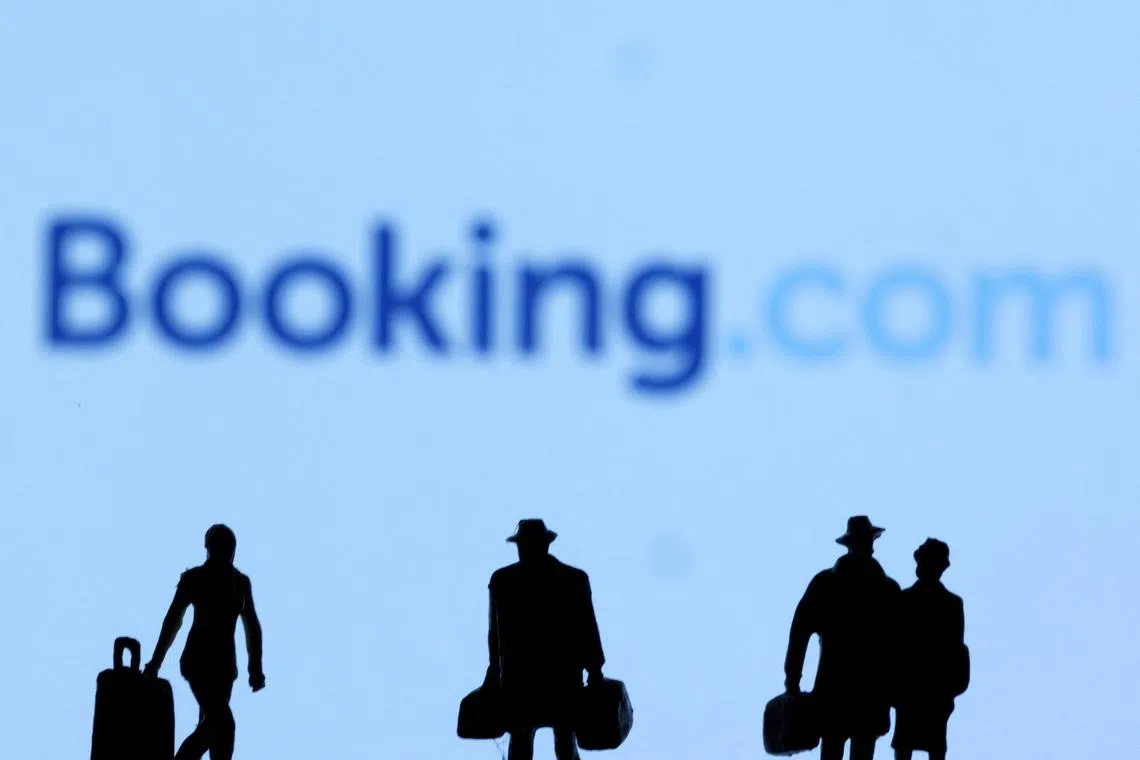 FILE PHOTO: Figurines are seen in front of the Booking.com logo in this illustration taken, February 27, 2022. REUTERS/Dado Ruvic/Illustration/File Photo