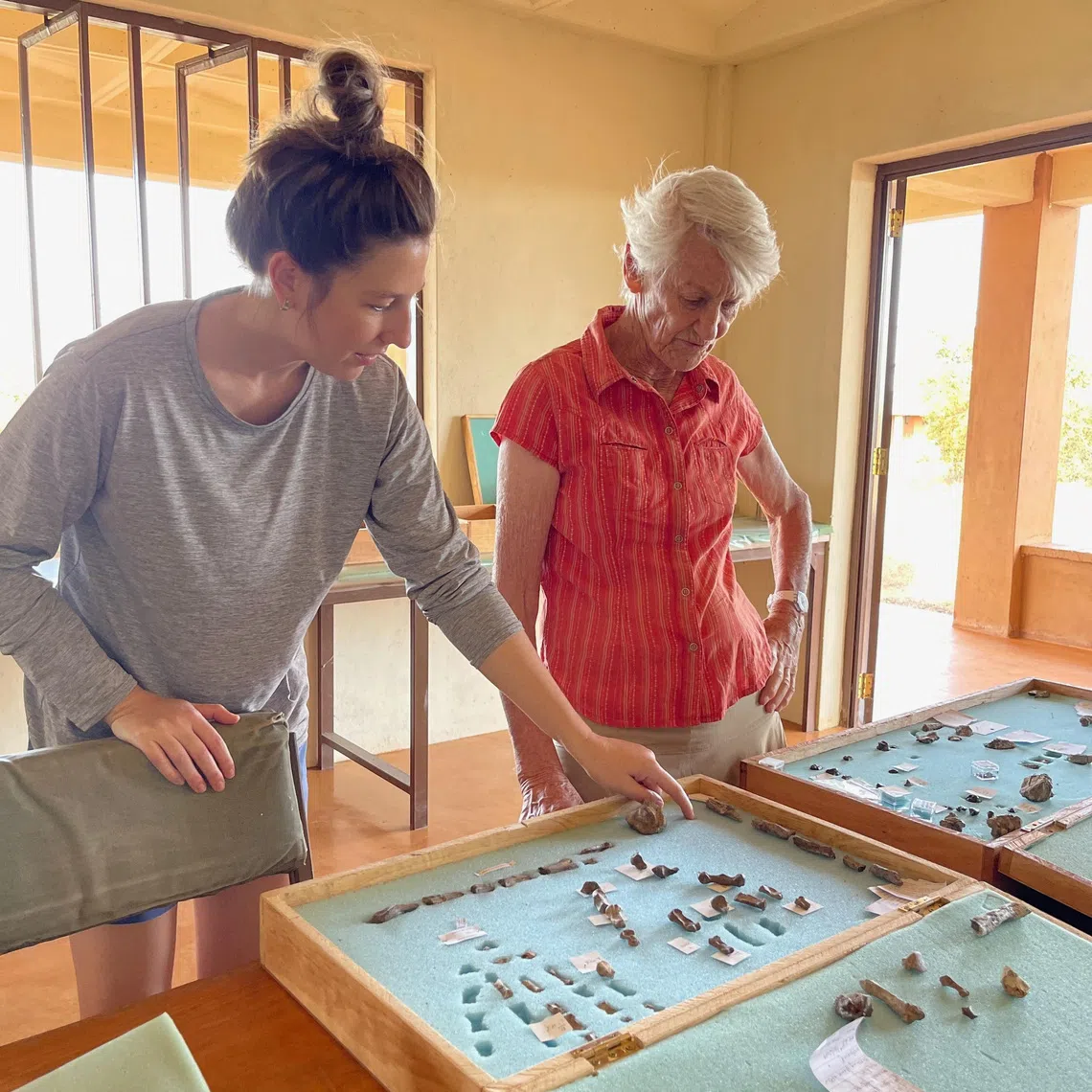 Researchers Carrie Mongle and Meave Leakey discuss Paranthropus boisei hand fossils, held in the cases pictured, at the Turkana Basin Institute research station in Ileret, Kenya, in this undated handout photograph. Louise Leakey/Handout via REUTERS