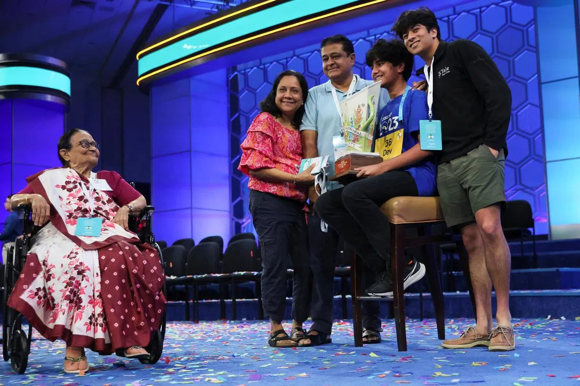Dev Shah, 14, holds the trophy accompanied by his father Deval Shah, his mother Nilam Shah, his brother Neil Shah and his grandmother Vinaben Shah after winning the Scripps National Spelling Bee competition in National Harbor, Maryland, U.S., on June 1, 2023.