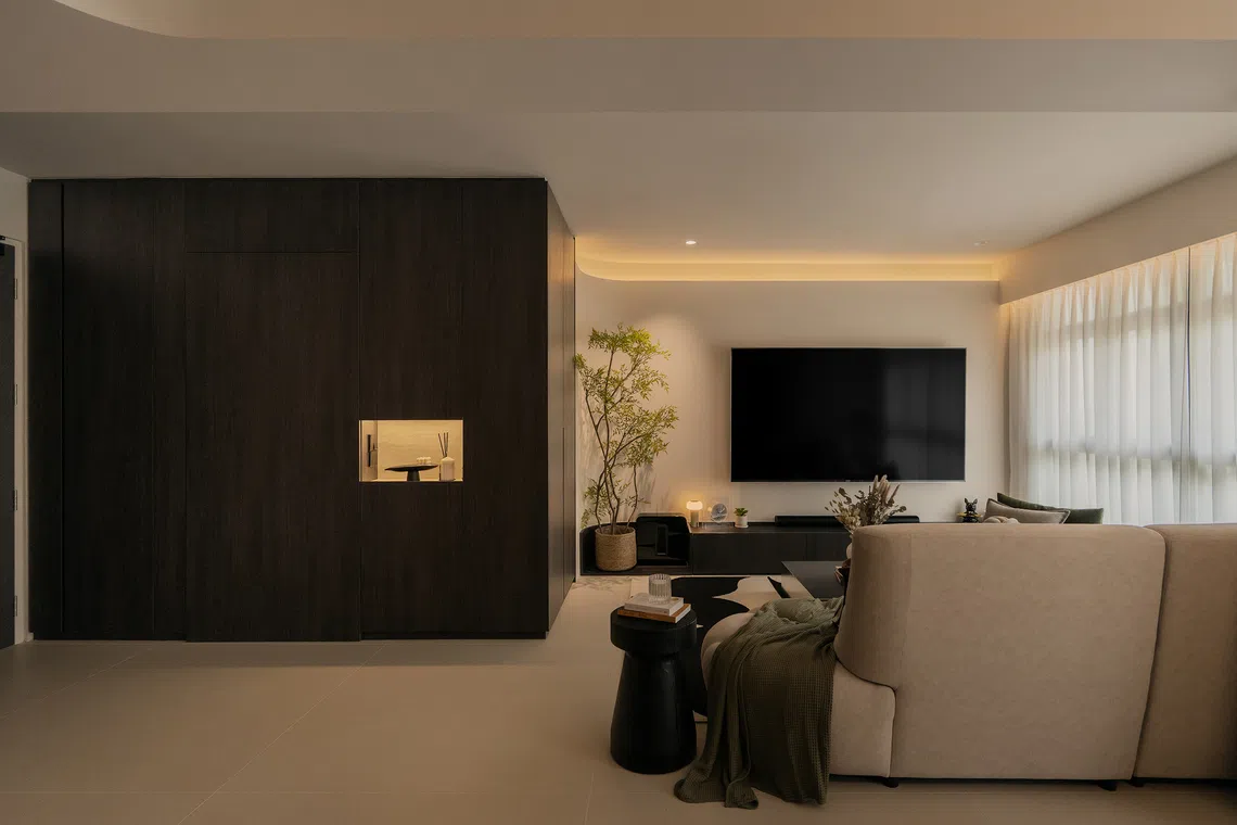 Gentle curves and layered lighting soften the angles of the rebuilt living room, with smart lighting for movie nights.