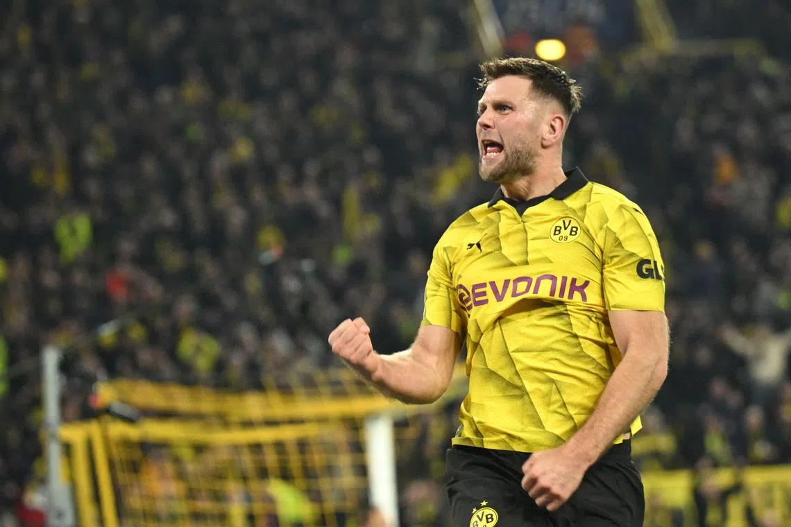 Dortmund forward Niclas Fuellkrug celebrates scoring his team's third goal.