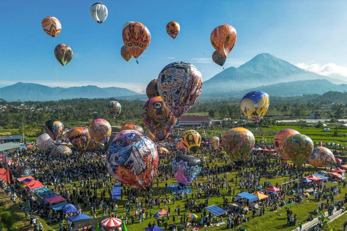 Hot air balloons decorated with traditional motifs are launched during the annual hot air balloon festival held to celebrate Eid al-Fitr, which marks the end of the Islamic holy fasting month of Ramadan, at Semayu village in Wonosobo, Central Java on March 23.