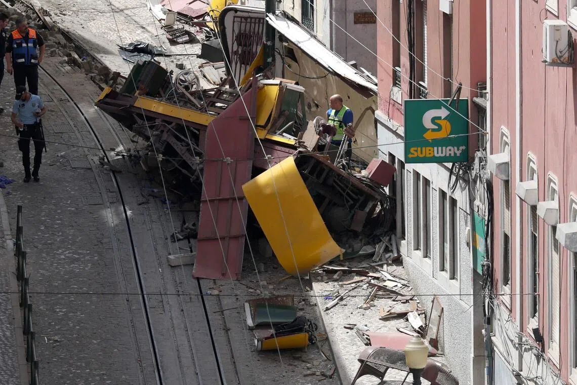 Police and civil protection members work on the site of the Gloria funicular accident that killed 16 a day earlier in Lisbon, on September 4, 2025. 