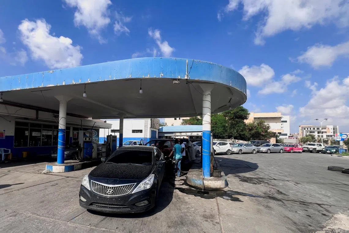 FILE PHOTO: A car stands while others line up to get fuel at a gas station in Misrata, Libya, August 29, 2024. REUTERS/Ayman Sahely