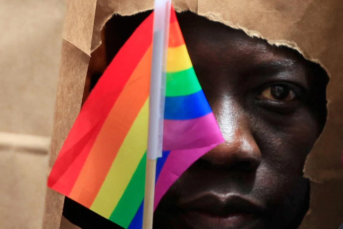 FILE PHOTO: An asylum seeker from Uganda covers his face with a paper bag in order to protect his identity as he marches with the LGBT Asylum Support Task Force during the Gay Pride Parade in Boston, Massachusetts June 8, 2013. REUTERS/Jessica Rinaldi/File Photo