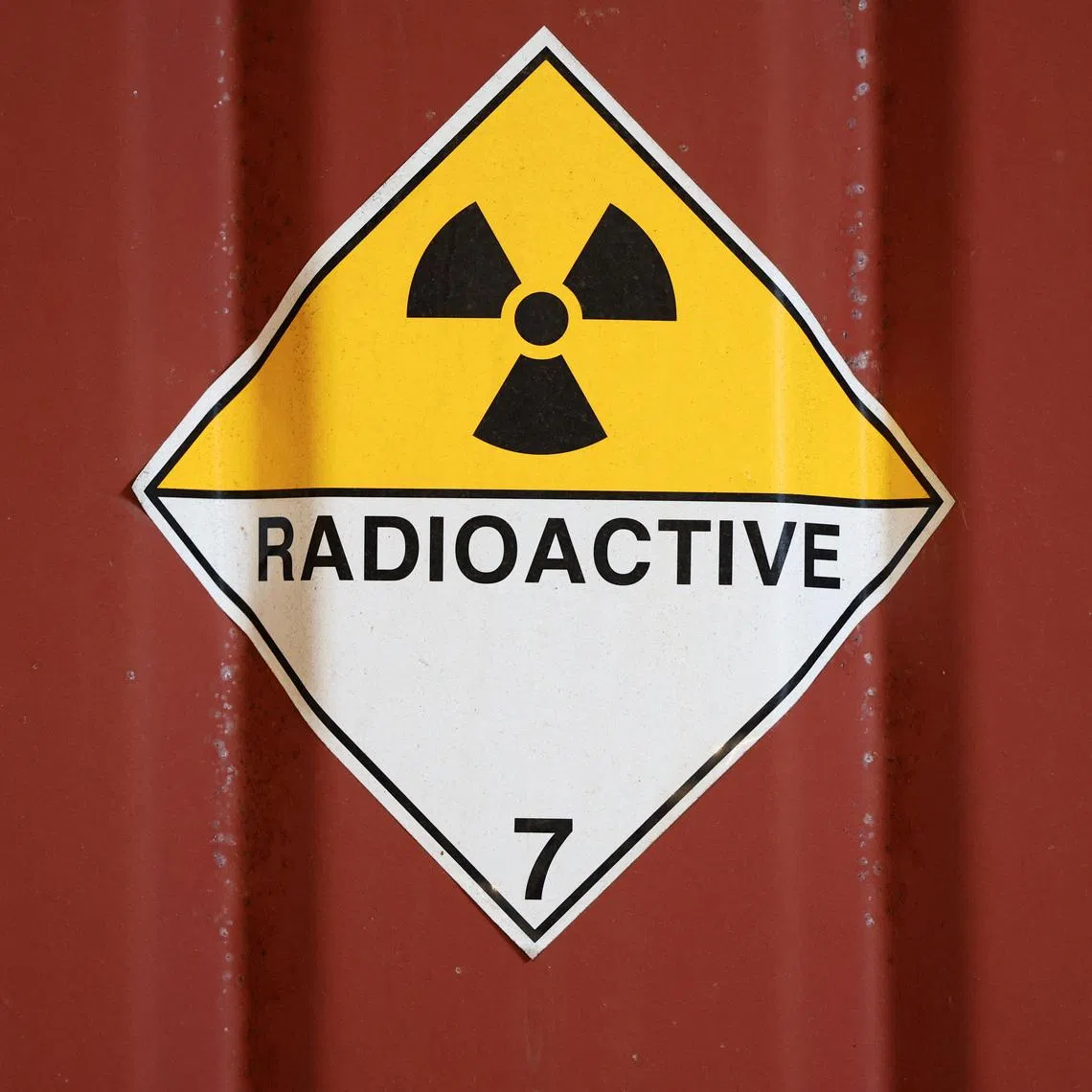 A radioactive sign is stuck to a container in the low-level waste vaults at the Dounreay nuclear site in Dounreay, Scotland, Britain November 25, 2025. REUTERS/Russell Cheyne