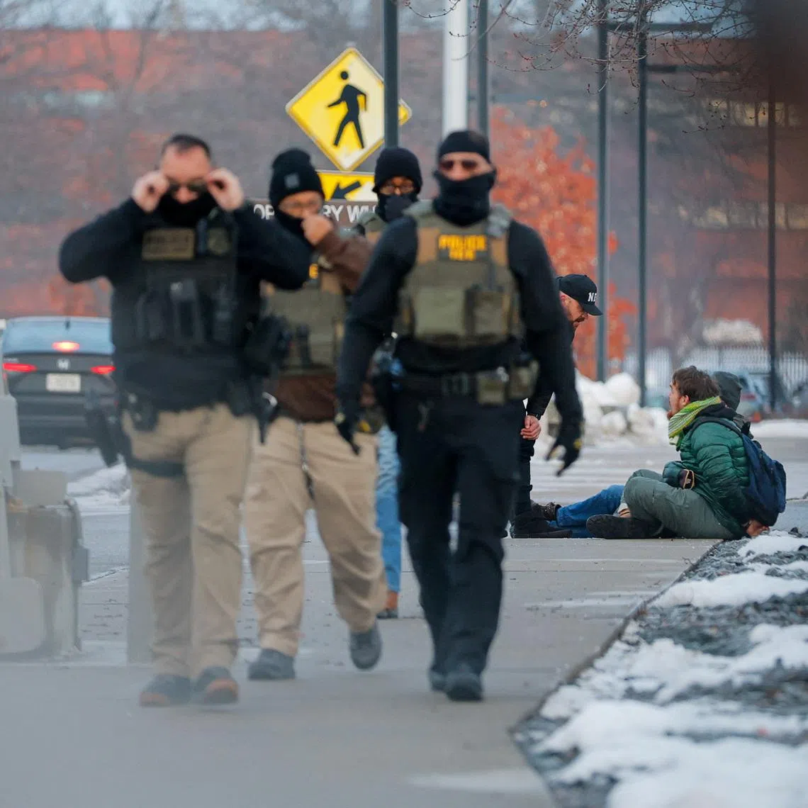 A federal agent speaks to detained demonstrators, during a protest against the fatal shooting of Renee Nicole Good on Jan 8.