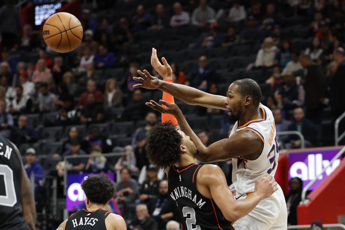 Phoenix Suns forward Kevin Durant (No. 35) passing on Detroit Pistons guard Cade Cunningham in the NBA game on Sunday.