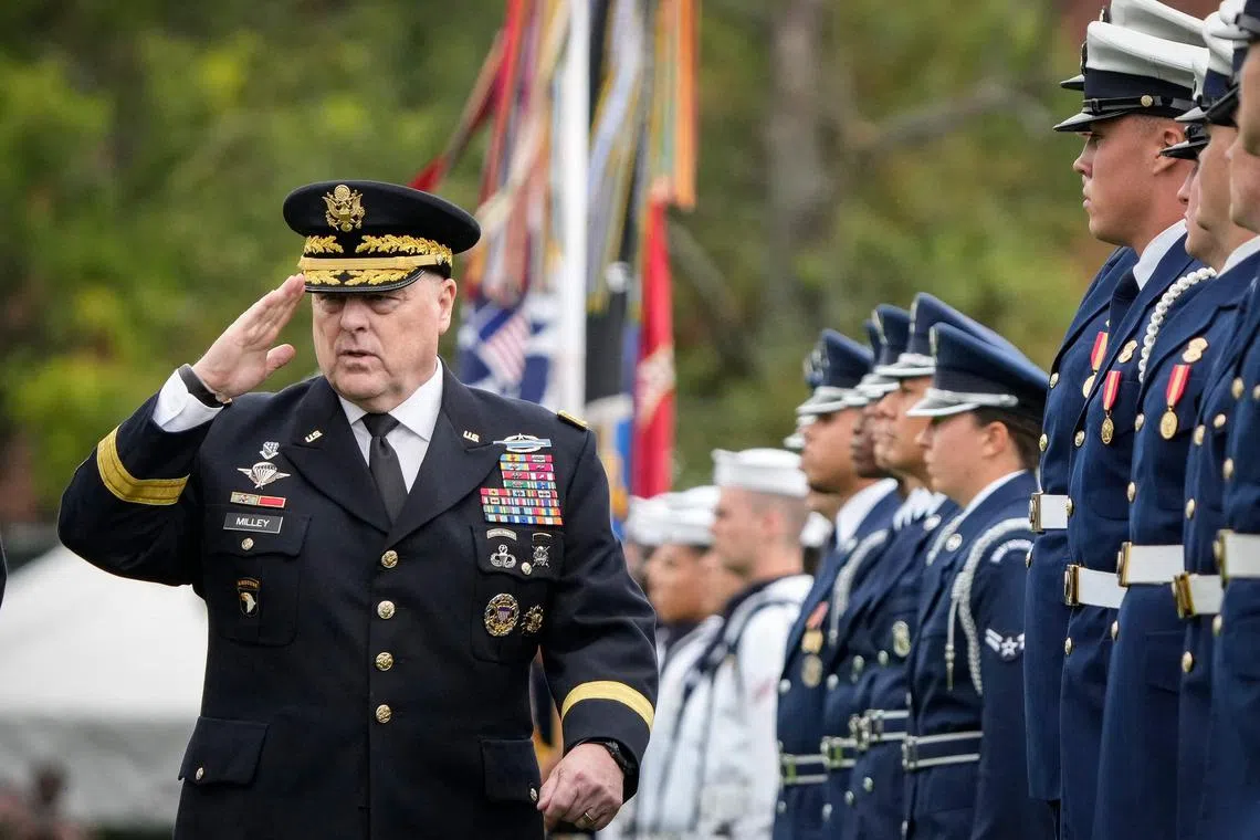 General Mark Milley inspects the troops, during a farewell tribute in his honour, in Arlington, Virginia.