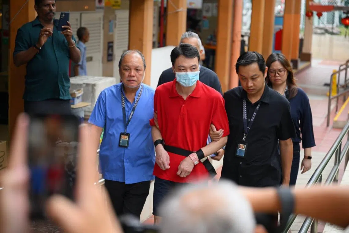 Chinese national Wu Tao, who is accused of killing Ms Tan Kamonwan, was brought back to the site at Maxwell Food Centre by the police on Oct 15.