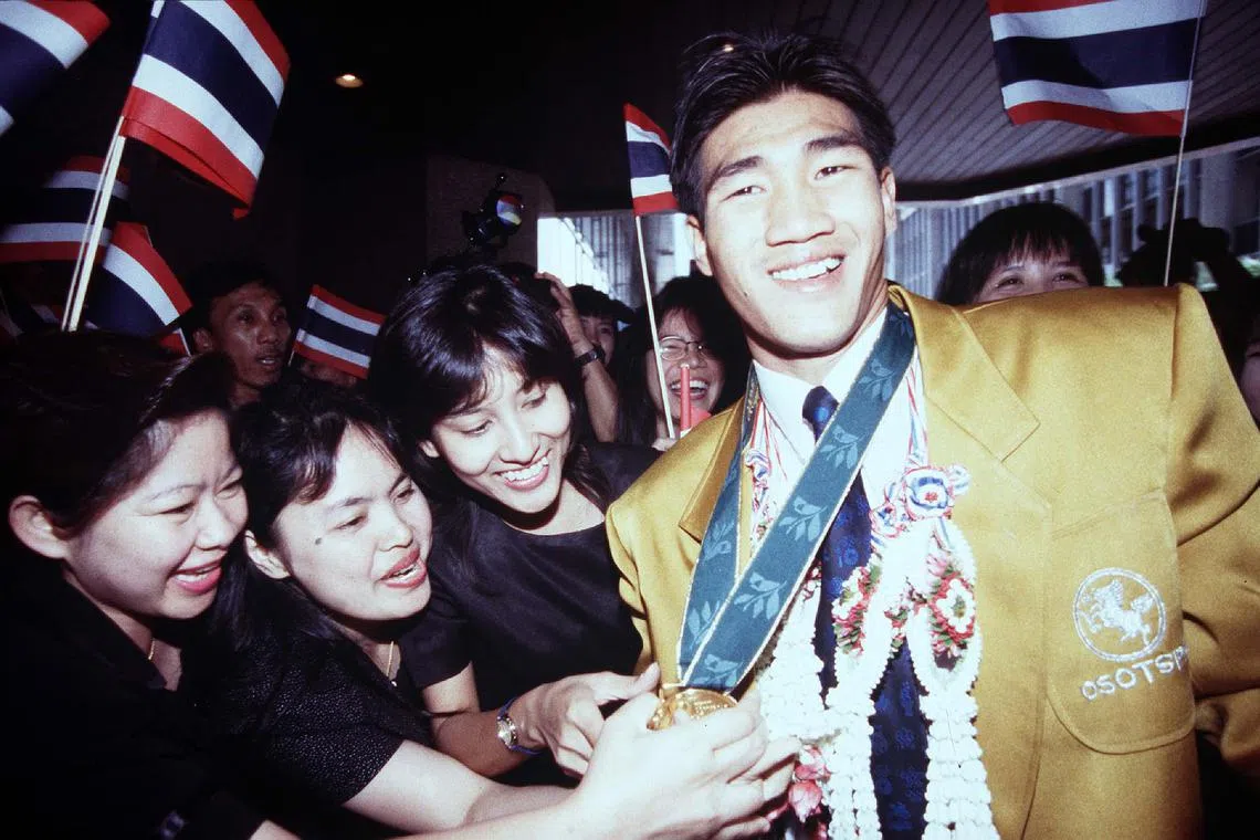 Somluck Kamsing upon his return from the 1996 Summer Olympics in Atlanta, where he won Thailand's first gold medal in boxing. He has been accused of sexually assaulting a teen. 