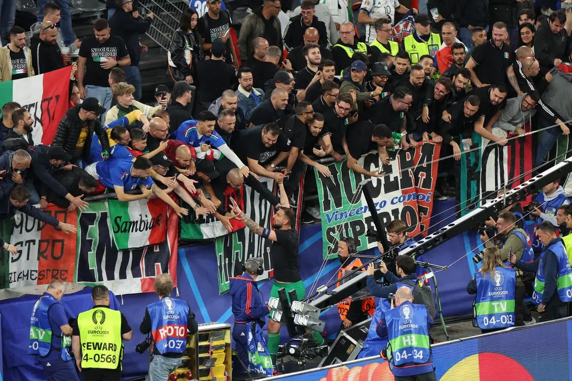 Goalkeeper Gianluigi Donnarumma of Italy celebrates with supporters after winning against Albania.