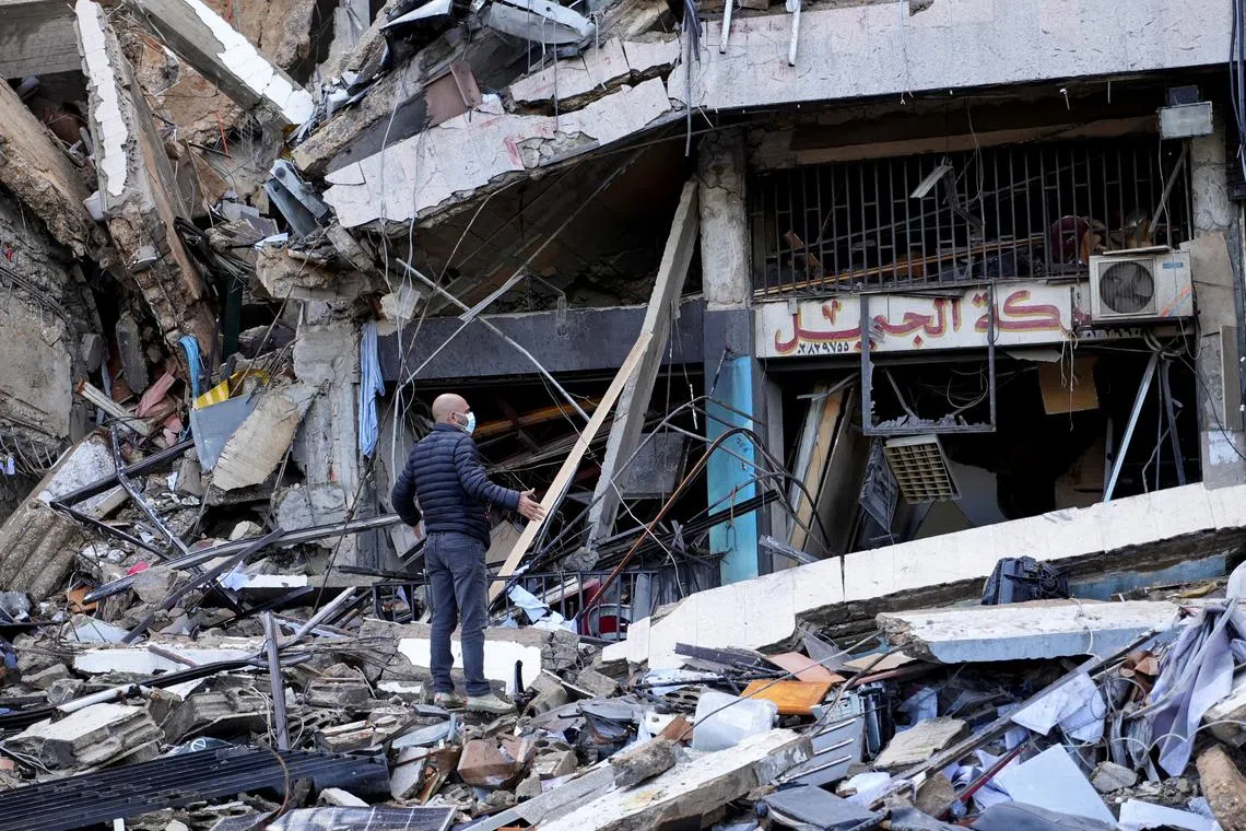 A man gestures as he stands on the rubble of a damaged site, in the aftermath of Israeli strikes on Beirut's southern suburbs, amid the ongoing hostilities between Hezbollah and Israeli forces, Lebanon November 26, 2024. REUTERS/Mohammed Yassin