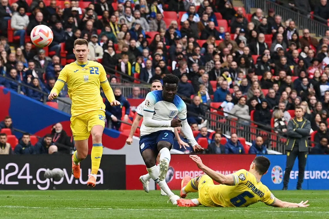 England's midfielder Bukayo Saka scores his team's second goal in London, on March 26, 2023.