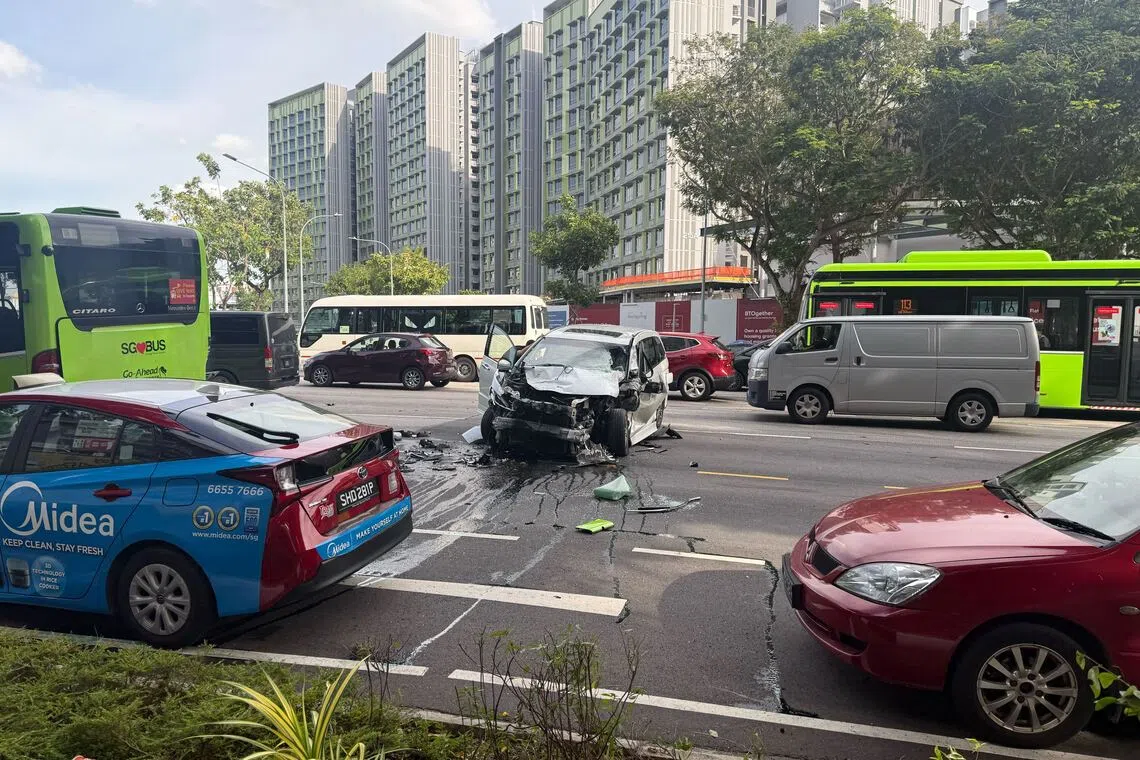 A black car with a damaged bumper and hood was seen on the third lane, with oil and debris surrounding it.