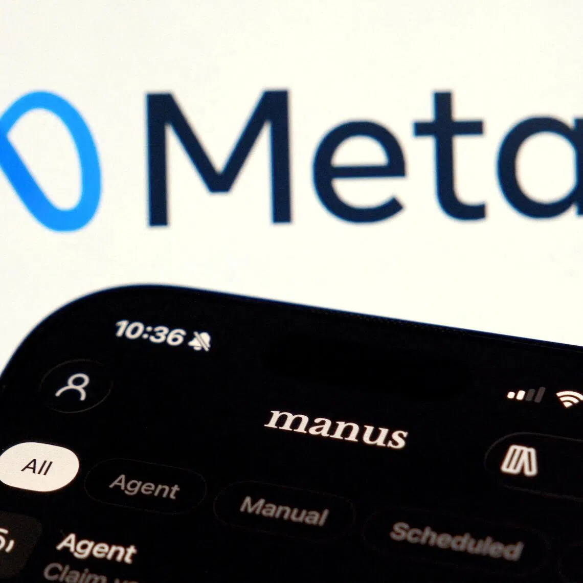 FILE PHOTO: The Manus AI agent app is displayed on a mobile phone near the logo of U.S. tech giant Meta, in this illustration picture taken April 28, 2026. REUTERS/Florence Lo/Illustration/File Photo