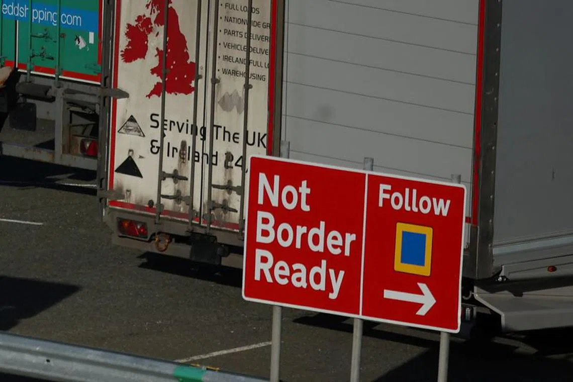 Heavy goods trailers are seen near a 'Not Border Ready' sign in a lorry park at the Port of Holyhead in Holyhead, Britain, January 30, 2024 REUTERS/Phil Noble