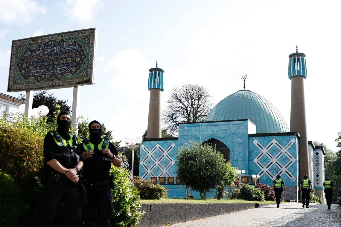 Police officers are seen in front of the Blue Mosque, housing the Hamburg Islamic Centre.