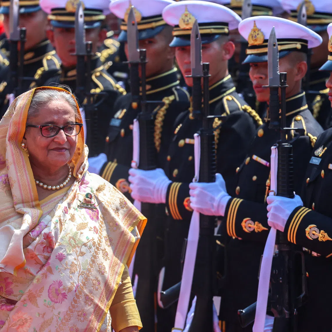 Sheikh Hasina reviews an honour guard at the Government House, during her visit to Thailand, in Bangkok, Thailand, April 26, 2024. REUTERS/Athit Perawongmetha
