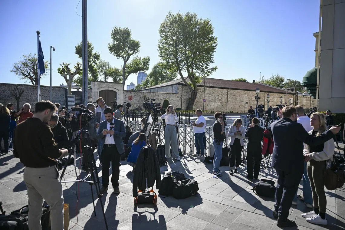 Journalists work outside the venue where peace talks between Moscow and Kiev are due to take place.  