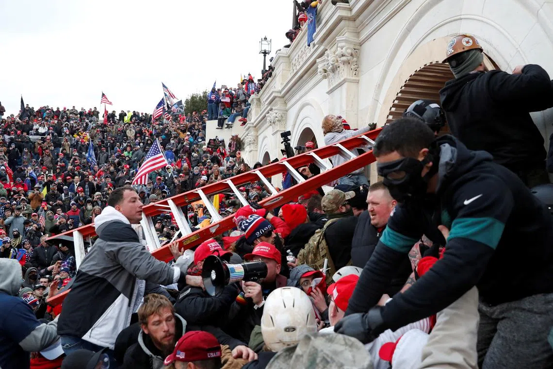 FILE PHOTO: Pro-Trump protesters storm into the U.S. Capitol during clashes with police, during a rally to contest the certification of the 2020 U.S. presidential election results by the U.S. Congress, in Washington, U.S, January 6, 2021. REUTERS/Shannon Stapleton/File Photo