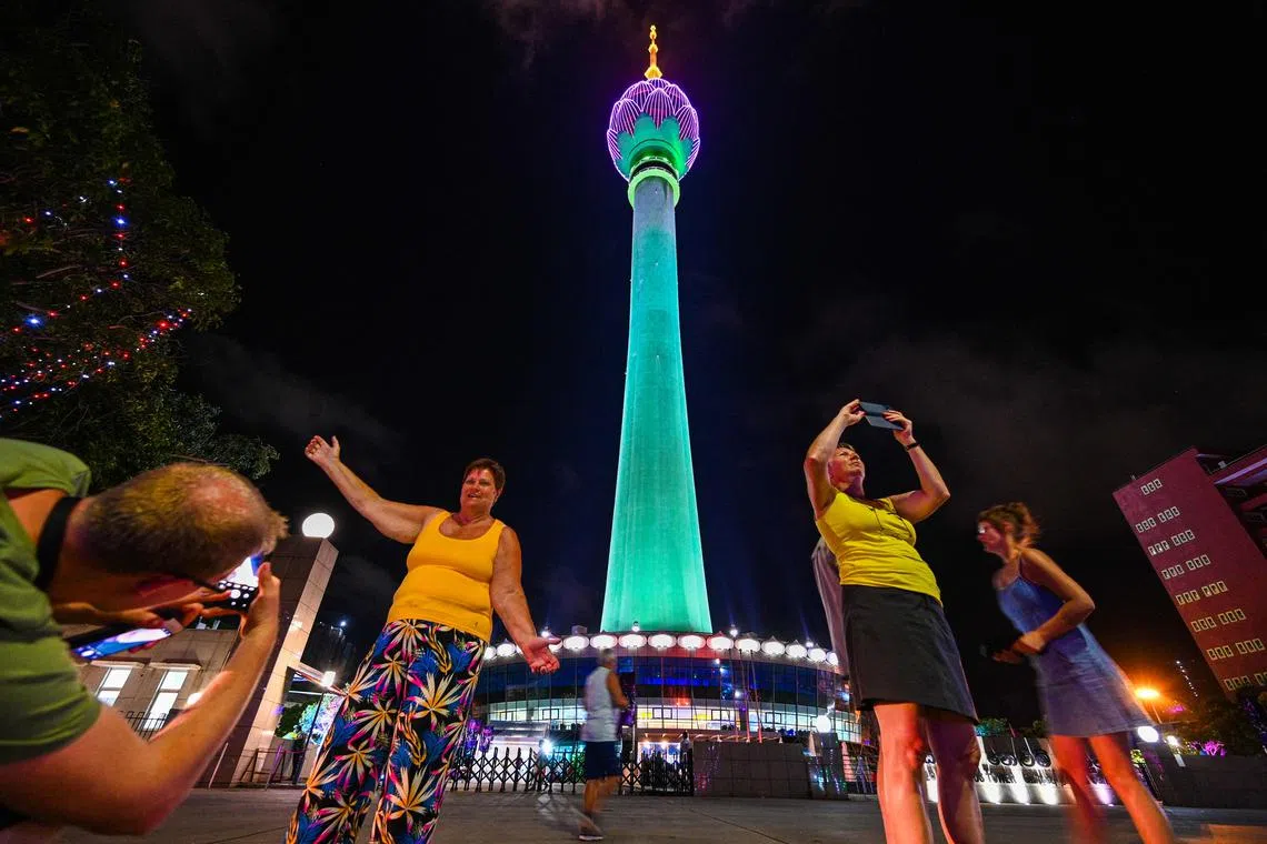 In this file photo taken on Sept 15, 2022, tourists take pictures in front of a Chinese-built Lotus Tower after it was opened to the public in Colombo, Sri Lanka. Sri Lanka said on Dec 1 it was reorganising its blackout-prone electricity grid to guarantee power to tourist resorts, in an effort to lure back foreign travellers after a bruising economic crisis. 