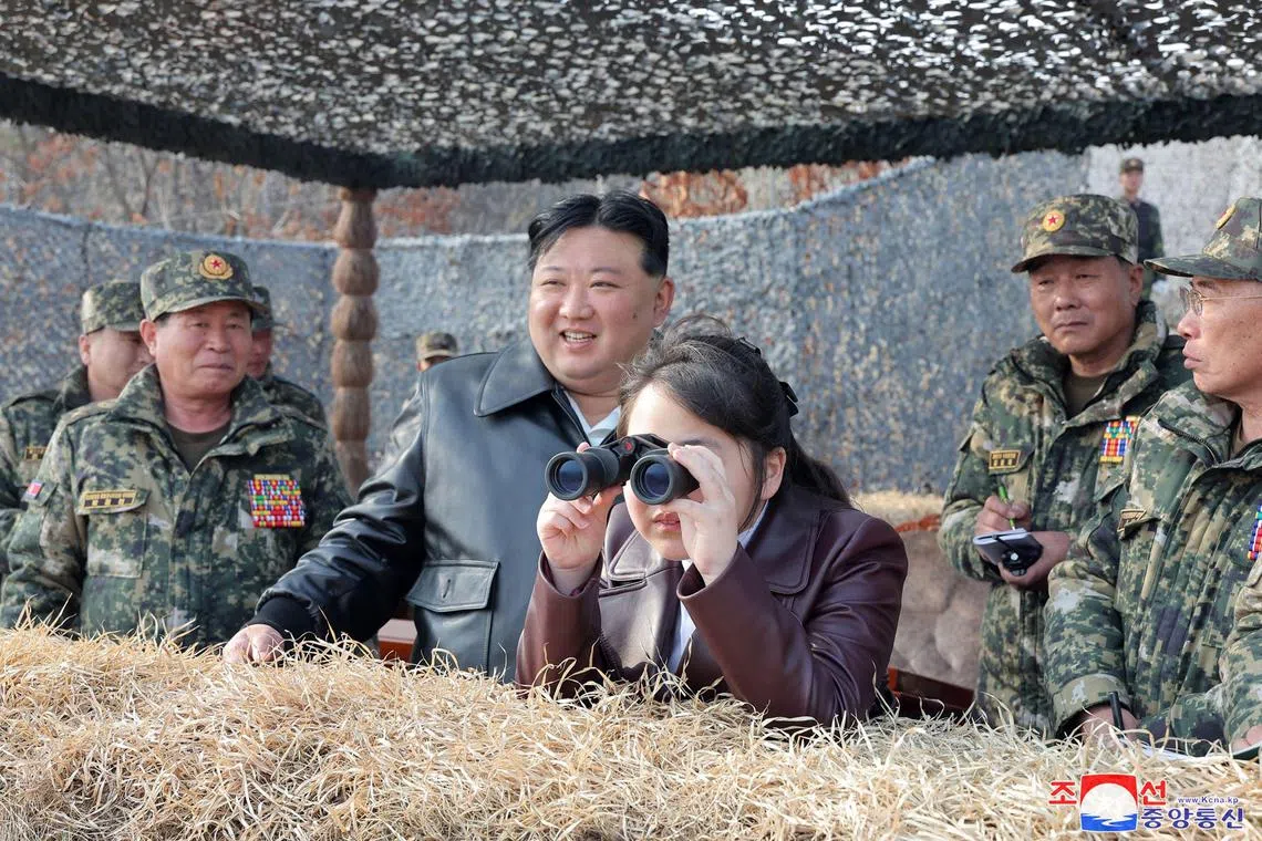 North Korean leader Kim Jong Un (centre L) and his daughter Ju Ae inspecting training of the Korean People's Army at an undisclosed location in North Korea.