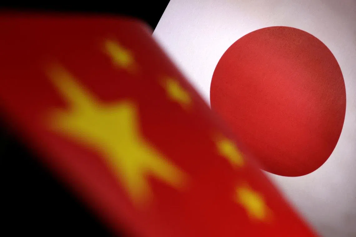 FILE PHOTO: Printed Chinese and Japanese flags are seen in this illustration, July 21, 2022. REUTERS/Dado Ruvic/Illustration/ File Photo