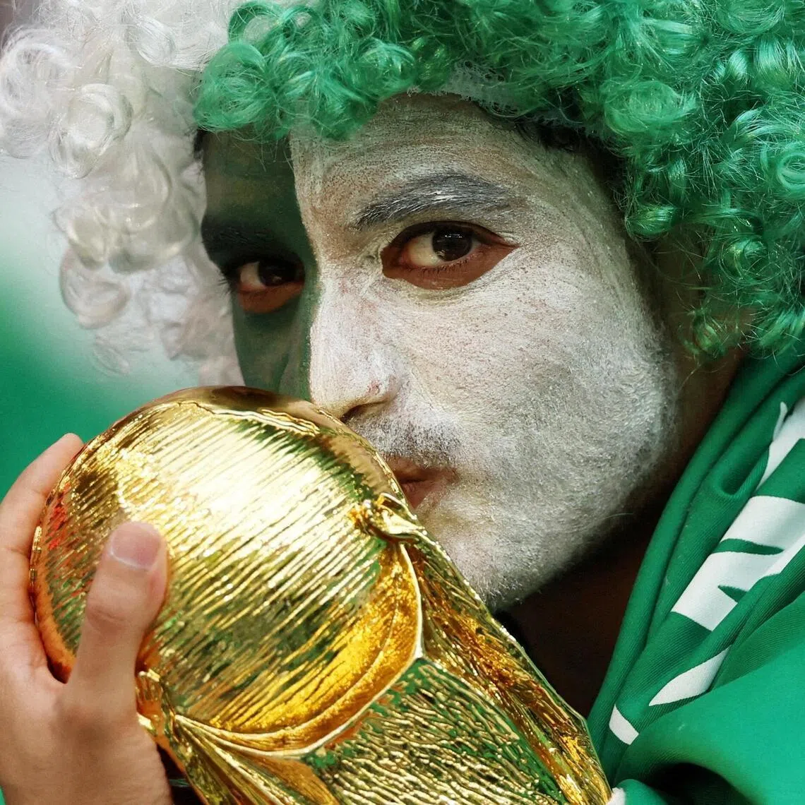 A Saudi Arabia fan with a replica World Cup trophy. The Saudis famously sprung one of the great World Cup upsets when they beat Argentina at the 2022 and are aiming to start strongly against Uruguay in this edition.