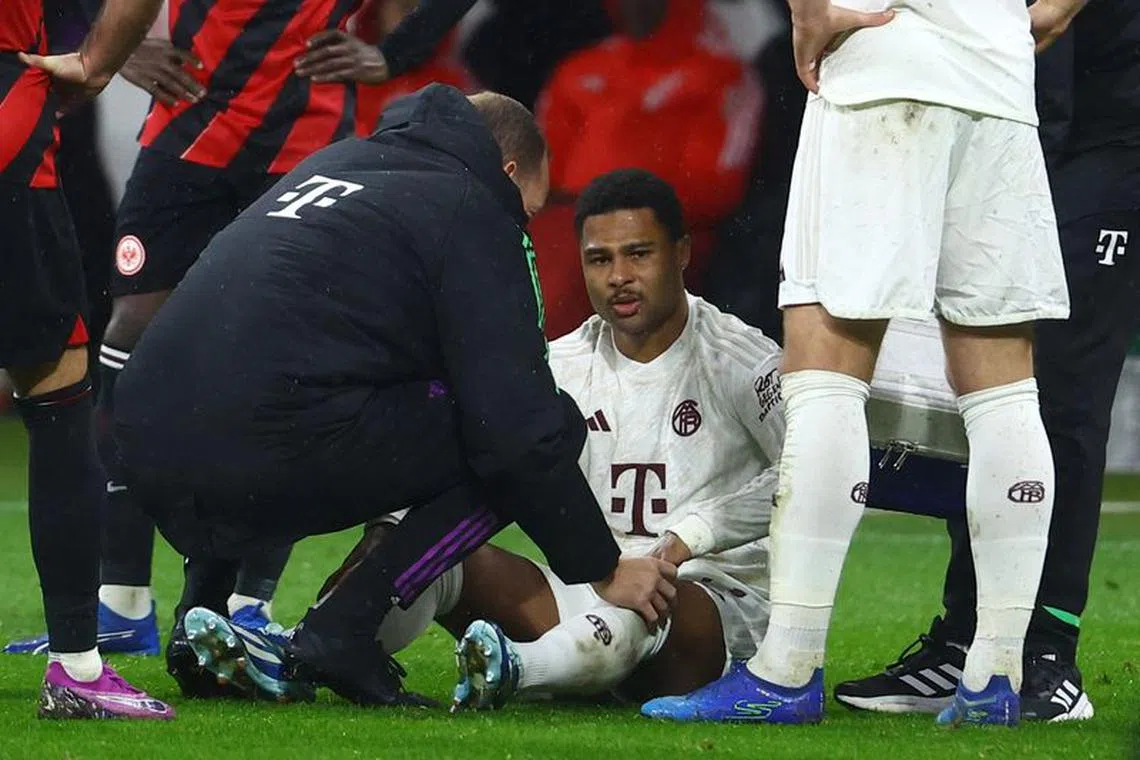 Soccer Football - Bundesliga - Eintracht Frankfurt v Bayern Munich - Deutsche Bank Park, Frankfurt, Germany - December 9, 2023 Bayern Munich's Serge Gnabry receives medical attention REUTERS/Kai Pfaffenbach/File Photo