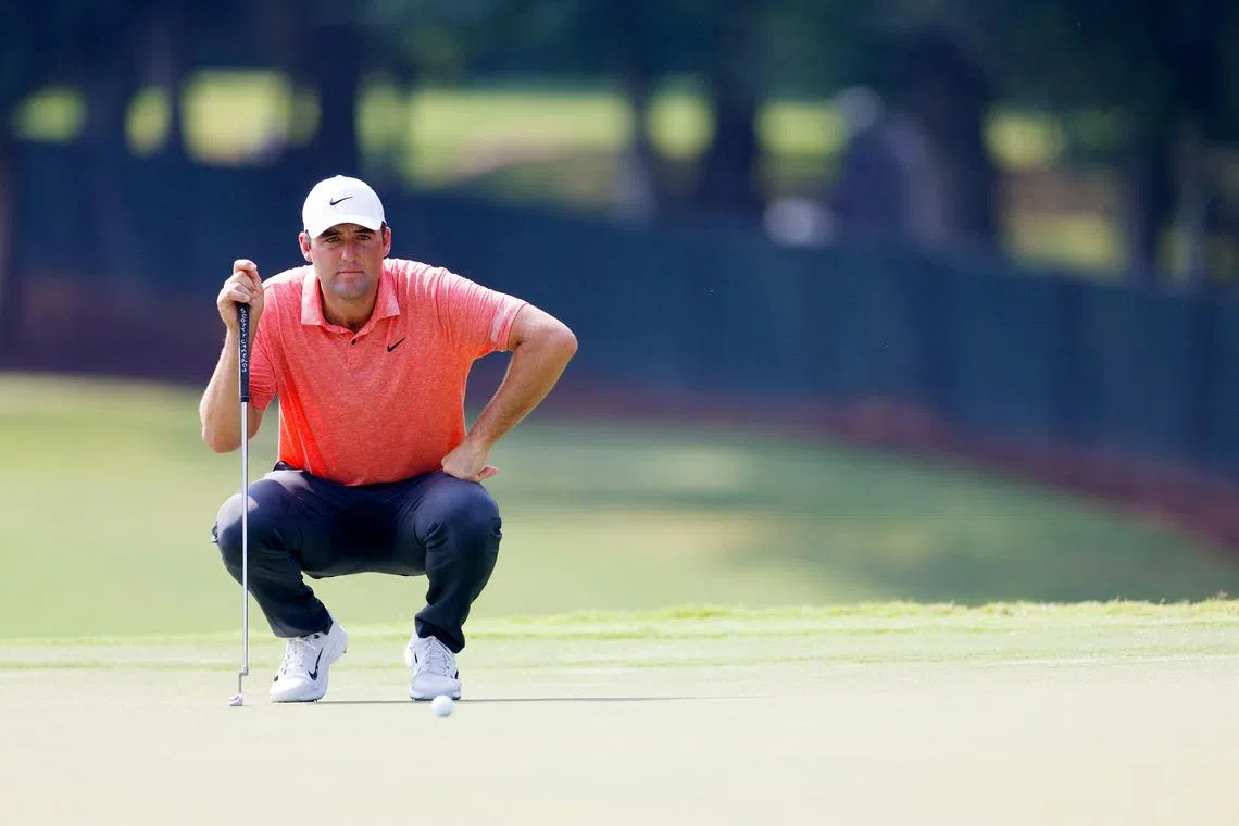 Scottie Scheffler lines up a putt on the 11th green during the first round of the Tour Championship.