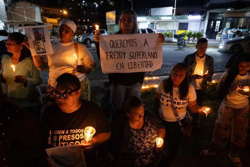 People participate in a vigil outside the Rodeo I prison in Zamora, Miranda state, Venezuela, on Jan 23, 2026.