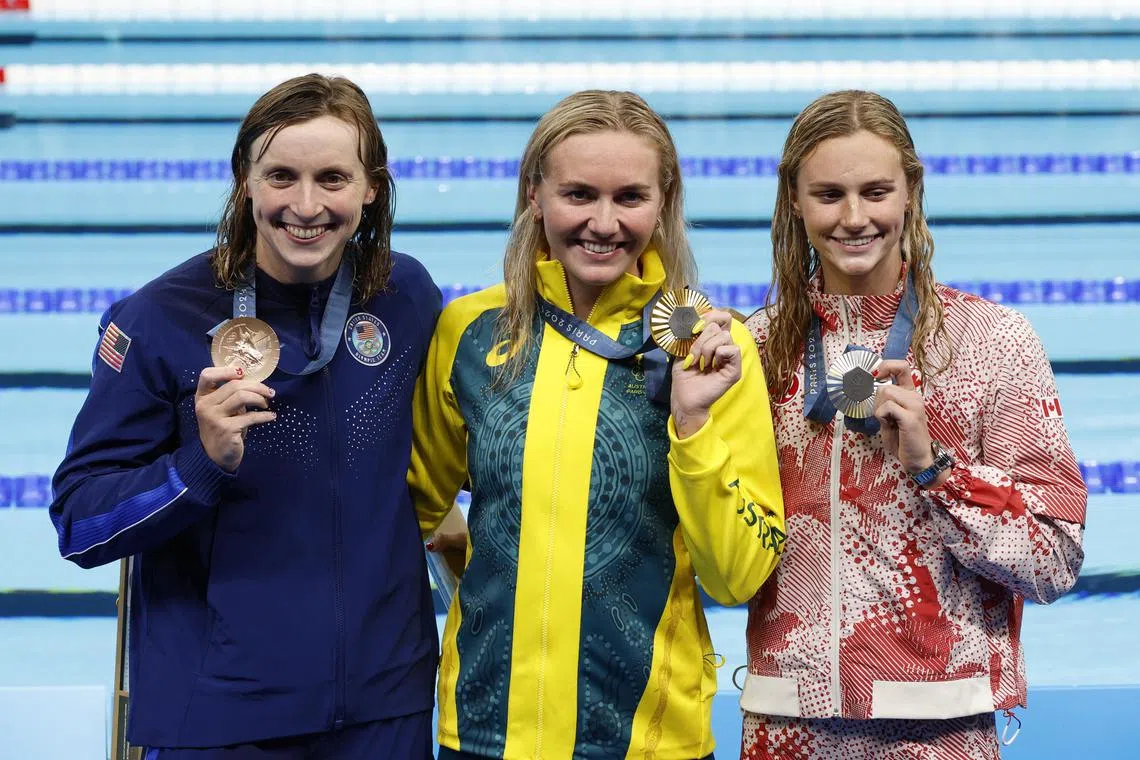 From left: Bronze medallist Katie Ledecky of the United States, gold medalist Ariarne Titmus of Australia, and silver medalist Summer McIntosh of Canada posing for photos after the 400m freestyle final.