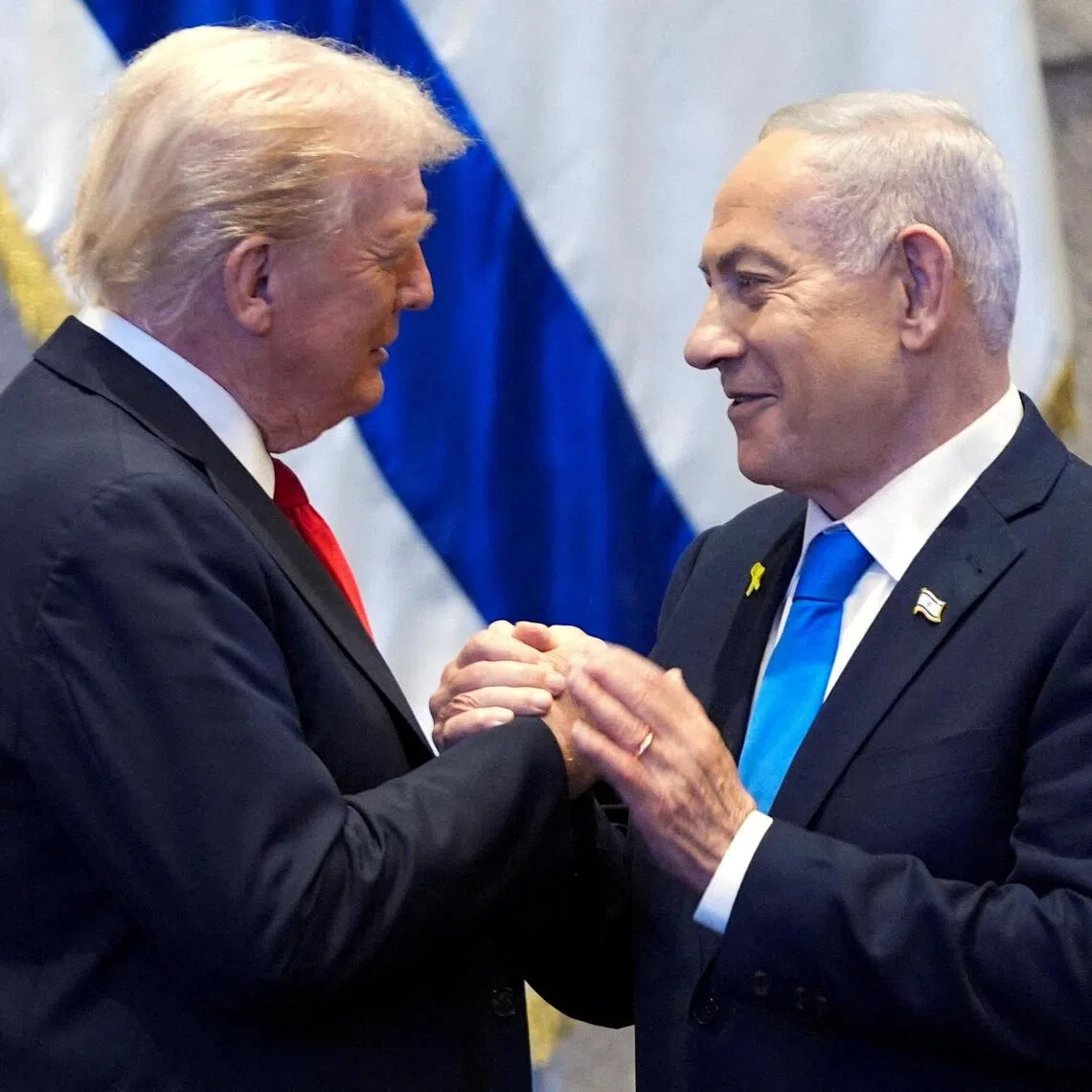 FILE PHOTO: President Donald Trump talks with Israel's Prime Minister Benjamin Netanyahu at the Knesset, Monday, Oct. 13, 2025, in Jerusalem.     Evan Vucci/Pool via REUTERS/File Photo