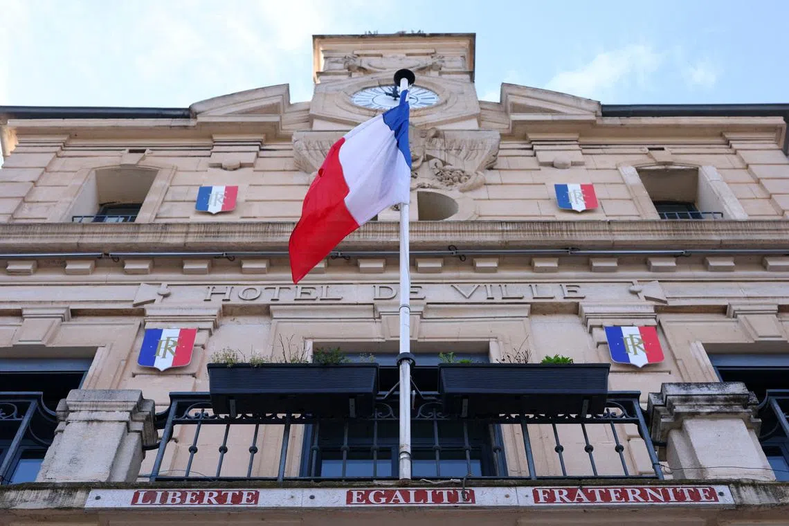 A French flag flies on the facade of the city hall of Gardanne ahead of upcoming mayoral election in France, March 4, 2026. REUTERS/Manon Cruz