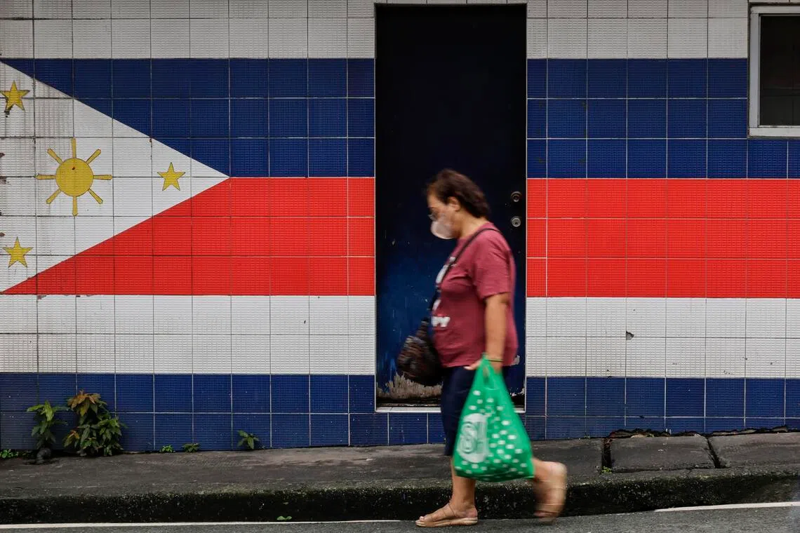 epa12416200 A person walks past an unused outpost for village patrol personnel in Mandaluyong City, Metro Manila, Philippines, 30 September 2025. Asian Development Bank (ADB) lowered its growth outlook for the Philippines from 6 percent to 5.6 percent for the year 2025 and from 6.1 percent to 5.7 percent for the year 2026, Asian Development Outlook (ADO) September 2025 report revealed.  EPA/ROLEX DELA PENA