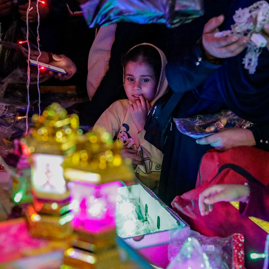 A Palestinian vendor sells traditional lanterns called 'fanous' in a market in Gaza City.