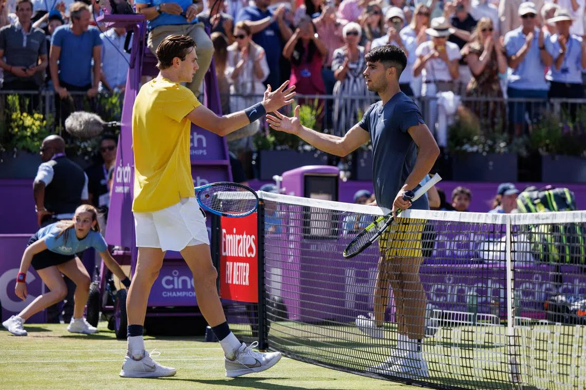 Britain's Jack Draper (left) shakes hands with Spain's Carlos Alcaraz after winning their second round match.