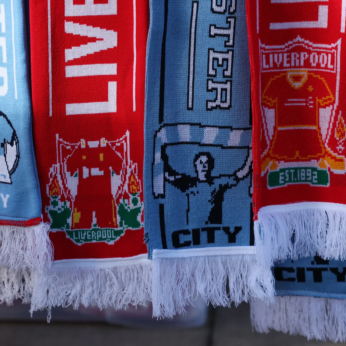 FILE PHOTO: Soccer Football - Premier League - Liverpool v Manchester City - Anfield, Liverpool, Britain - December 1, 2024  Liverpool and Manchester City scarfs are seen outside the stadium before the match REUTERS/Phil Noble/File Photo