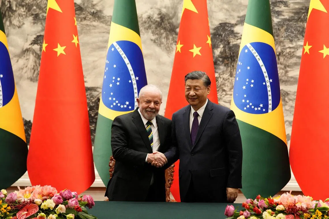 Brazilian President Luiz Inacio Lula da Silva shakes hands with Chinese President Xi Jinping after a signing ceremony in Beijing on April 14, 2023. 