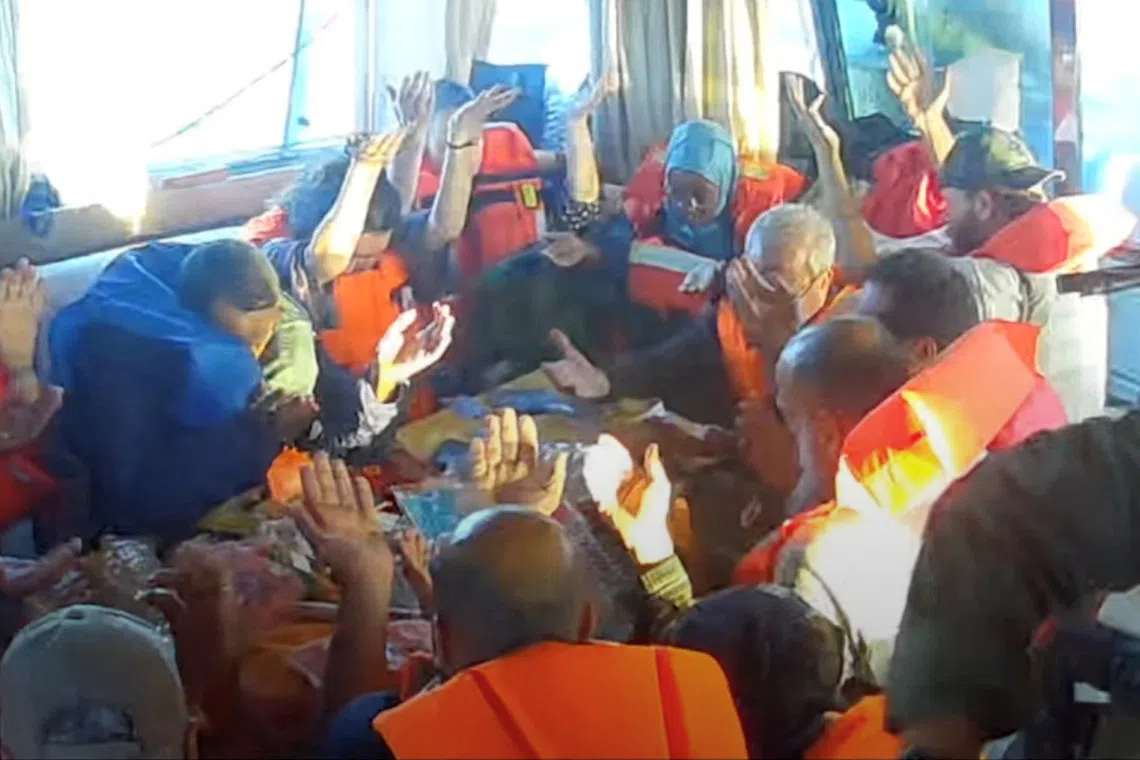 Crew raising their hands after Israeli navy forces boarded the Gaza-bound vessel Florida, part of the Global Sumud Flotilla, on Oct 2.