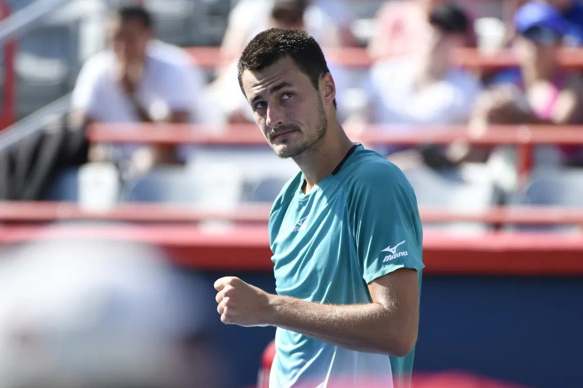 FILE PHOTO: Aug 4, 2019; Montreal, Quebec, Canada; Bernard Tomic of Australia reacts after defeating Marc Polmans of Australia (not pictured) during the Rogers Cup tennis tournament at Stade IGA. Mandatory Credit: Eric Bolte-USA TODAY Sports/File Photo